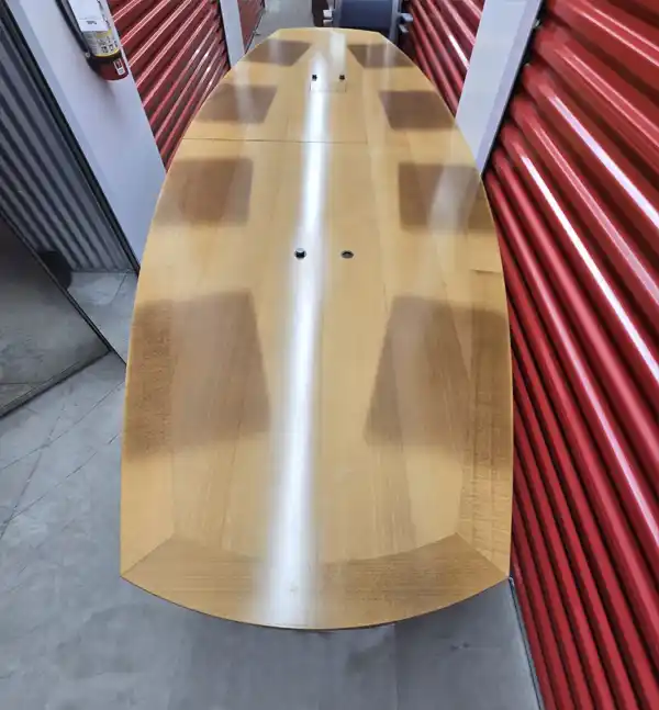 20-foot wood conference table with integrated speaker ports, shown from top view