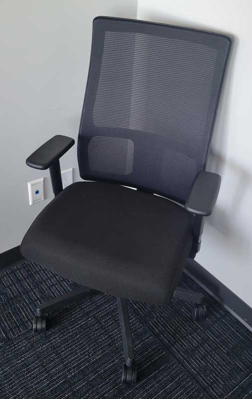 Used Paoli Fire Task Chair with black mesh back and upholstered seat, with adjustable arms.