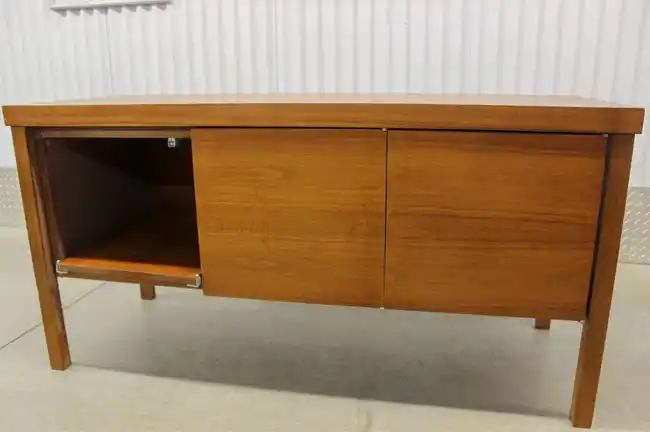Front of rosewood credenza with 3 doors and one opened to show storage