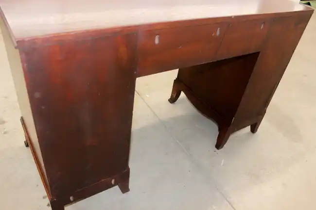 Close-up of rear leg and apron on traditional desk