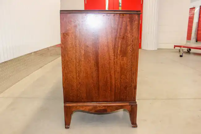 Side panel view of kneehole desk showing grain and base detail