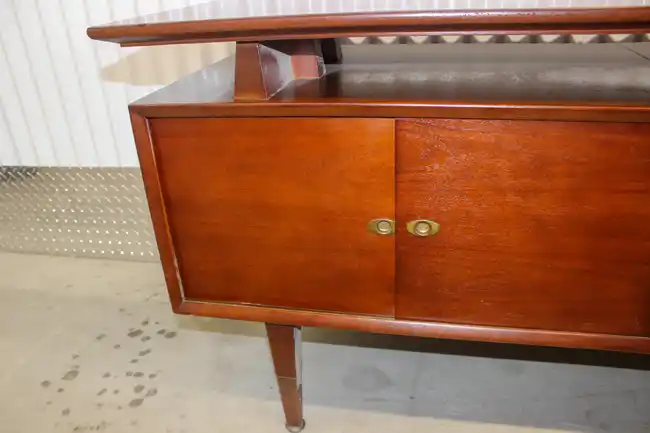 Interior of rosewood credenza showing two-door storage cabinet