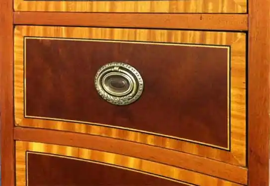 Close-up of desk inlay and brass drawer pull