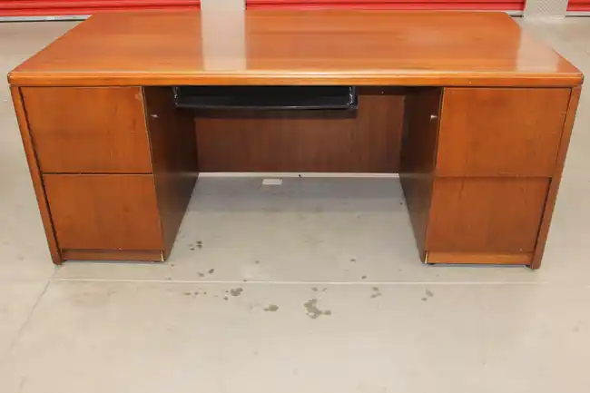 Under-desk view showing keyboard tray and pedestal drawers