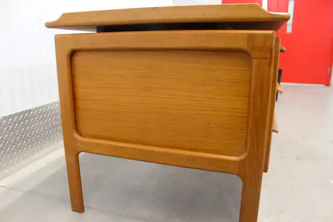 Angled view showing desk depth and right pedestal