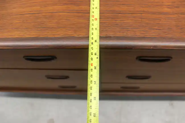 Close-up of dresser height with measuring tape